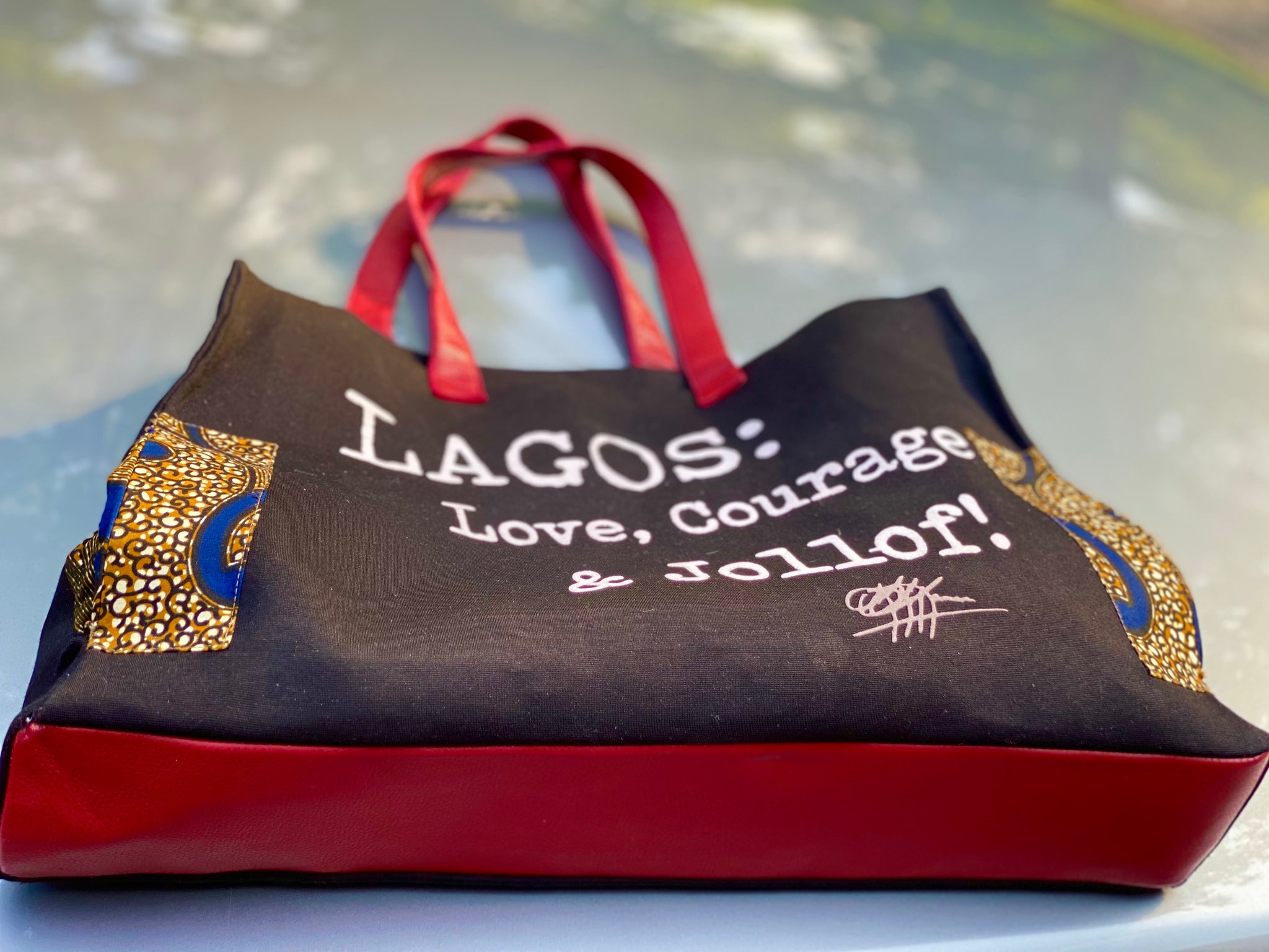 Trapezoid Leather Trim Tote: LAGOS: Love, Courage &Jollof